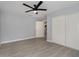 Light grey bedroom with ceiling fan, tile floors and white closet doors at 2524 Dellwood Dr, Orlando, FL 32806