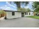 Large backyard with artificial turf, patio, and playset at 2524 Dellwood Dr, Orlando, FL 32806