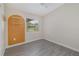 Bedroom with grey tile floors, an accent wall and a window with blinds at 2524 Dellwood Dr, Orlando, FL 32806