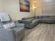 Relaxing living room with gray leather sectional and ocean art at 1404 N Atlantic Ave # 4, Daytona Beach, FL 32118