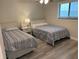 Guest bedroom with two twin beds and coastal decor at 1404 N Atlantic Ave # 4, Daytona Beach, FL 32118