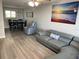 Spacious living room featuring gray leather sectional sofa and dining area at 1404 N Atlantic Ave # 4, Daytona Beach, FL 32118