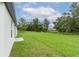 Spacious backyard with green grass and mature trees at 11 Spruce Pass, Ocala, FL 34472