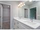 Double vanity bathroom with walk-in closet access at 11 Spruce Pass, Ocala, FL 34472