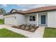 Single-story home with attached garage, landscaping, and a teal front door at 11 Spruce Pass, Ocala, FL 34472