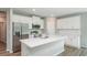 Island kitchen with white cabinets and stainless steel appliances at 11 Spruce Pass, Ocala, FL 34472