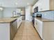 Modern kitchen with white cabinets and granite countertops at 1502 Jadewood Way, Kissimmee, FL 34744