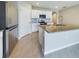 Kitchen island with granite countertop and stainless steel appliances at 1502 Jadewood Way, Kissimmee, FL 34744