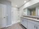 Bathroom boasts double sinks, granite countertop, and shower at 1502 Jadewood Way, Kissimmee, FL 34744