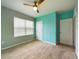 Bedroom with gray and teal walls, neutral carpet, and a ceiling fan at 1502 Jadewood Way, Kissimmee, FL 34744