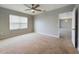 Bedroom with ceiling fan, window blinds, and access to another room at 1502 Jadewood Way, Kissimmee, FL 34744