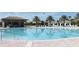 Large community pool with a swim-up bar and plenty of lounge chairs at 8975 Azalea Sands Ln, Davenport, FL 33896