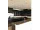 Modern kitchen with dark cabinets and stainless steel appliances at 8975 Azalea Sands Ln, Davenport, FL 33896