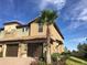 Tan two story townhome with a double garage at 8975 Azalea Sands Ln, Davenport, FL 33896