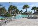 Relaxing pool area with lounge chairs and palm trees at 8975 Azalea Sands Ln, Davenport, FL 33896