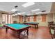 Game room with two billiard tables and comfortable seating at 343 Indian Wells Ave, Kissimmee, FL 34759