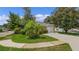 Tan house with white garage door, lush landscaping, and a long driveway at 360 Placid Lake Dr, Sanford, FL 32773