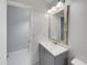 Clean bathroom with gray vanity and a wood-framed mirror at 112 Winterglen Dr, Sanford, FL 32771