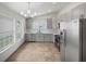 Modern kitchen featuring gray cabinets and stainless steel appliances at 112 Winterglen Dr, Sanford, FL 32771