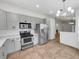 Modern kitchen with gray shaker cabinets and stainless steel appliances at 112 Winterglen Dr, Sanford, FL 32771