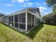 Home features a screened porch and grassy backyard at 112 Winterglen Dr, Sanford, FL 32771