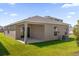 House exterior showcasing backyard and covered patio at 607 Alder Ln, Auburndale, FL 33823