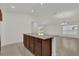 Open concept kitchen with island and view to living room at 607 Alder Ln, Auburndale, FL 33823