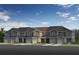 Three-unit townhouse building with attached garages and well maintained lawn at 426 Sequoia Dr, Lake Wales, FL 33859