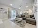 Spacious living room with sectional sofa and large sliding glass doors at 7740 Sandy Ridge Dr # 100, Reunion, FL 34747