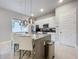 Modern kitchen with island, stainless steel appliances, and white cabinetry at 7740 Sandy Ridge Dr # 100, Reunion, FL 34747