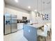 Modern kitchen with stainless steel appliances and a large island at 7740 Sandy Ridge Dr # 100, Reunion, FL 34747