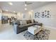 Open concept living room with modern sectional sofa and kitchen views at 7740 Sandy Ridge Dr # 100, Reunion, FL 34747