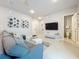 Living area features a sectional sofa, large TV, and bathroom access at 7740 Sandy Ridge Dr # 100, Reunion, FL 34747
