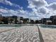 Community pool area with lounge chairs and umbrellas at 7740 Sandy Ridge Dr # 100, Reunion, FL 34747