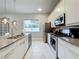 Modern kitchen with stainless steel appliances and gray countertops at 7740 Sandy Ridge Dr # 100, Reunion, FL 34747