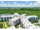 Condo building with a large parking area and surrounding trees at 14501 Grove Resort Ave # 3132, Winter Garden, FL 34787