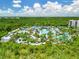 Aerial view of resort-style pool with waterslides and lush landscaping at 14501 Grove Resort Ave # 3132, Winter Garden, FL 34787
