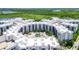 Aerial view of a large condo complex with surrounding green space at 14501 Grove Resort Ave # 3132, Winter Garden, FL 34787