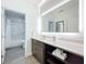 Modern bathroom with illuminated vanity mirror and bathtub at 14501 Grove Resort Ave # 3132, Winter Garden, FL 34787