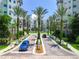 Gated community entrance with palm trees and lush landscaping at 14501 Grove Resort Ave # 3132, Winter Garden, FL 34787