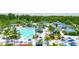 Resort-style pool with waterslides, expansive deck, and lush landscaping at 14501 Grove Resort Ave # 3132, Winter Garden, FL 34787