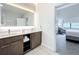 Modern bathroom with double vanity, view of bedroom, and walk-in shower at 14501 Grove Resort Ave # 3132, Winter Garden, FL 34787