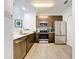 Modern kitchen with stainless steel appliances and wood cabinets at 14501 Grove Resort Ave # 3132, Winter Garden, FL 34787
