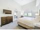 Main bedroom with king-size bed, dresser, and ensuite bathroom at 14501 Grove Resort Ave # 3132, Winter Garden, FL 34787