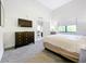 Bedroom with a queen bed, dresser, and access to the living room at 14501 Grove Resort Ave # 3132, Winter Garden, FL 34787