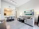 Open living room with L-shaped sectional sofa, dining area, and kitchen views at 14501 Grove Resort Ave # 3132, Winter Garden, FL 34787