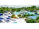 Large pool area with multiple pools, loungers, and tropical landscaping at 14501 Grove Resort Ave # 3132, Winter Garden, FL 34787
