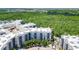 Condo building with a parking lot and surrounding trees at 14501 Grove Resort Ave # 3132, Winter Garden, FL 34787