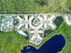 Top-down view of resort with pool, lake, and lush landscaping at 14501 Grove Resort Ave # 3132, Winter Garden, FL 34787
