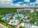 Aerial view of resort-style pool with waterslides, and nearby condos at 14501 Grove Resort Ave # 3132, Winter Garden, FL 34787
